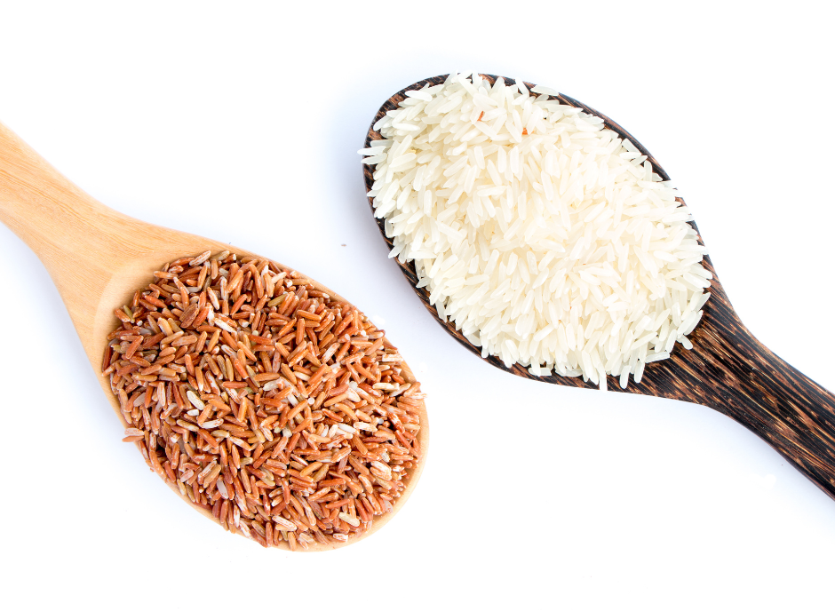 Rice and brown rice in wooden spoon on white background.