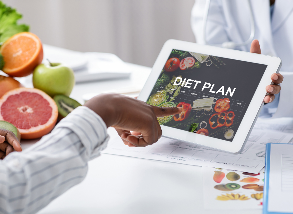 A person pointing at a tablet with a diet plan on it.