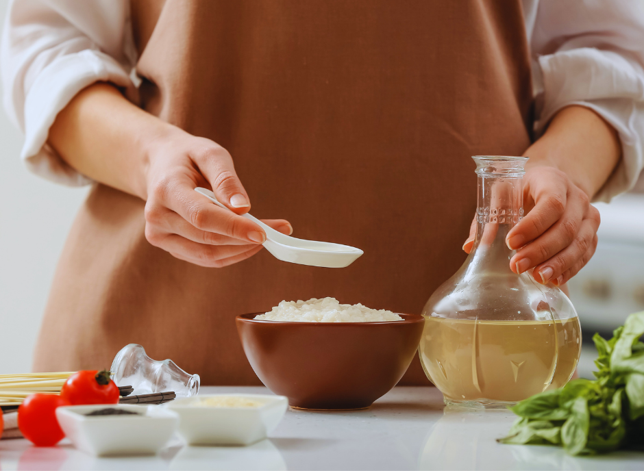 A woman is mixing ingredients in a bowl of rice.