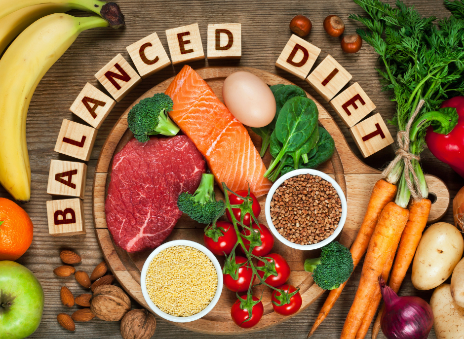 The word balanced diet is spelled out on a wooden board.