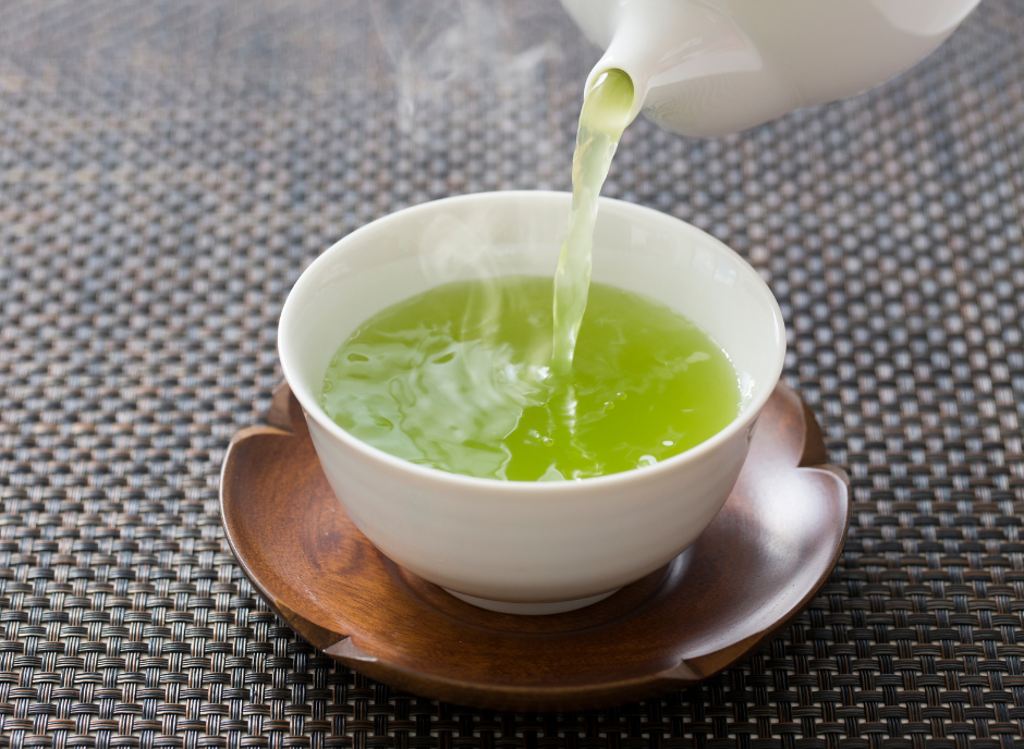 A cup of green tea is being poured into a kidney-friendly candy.