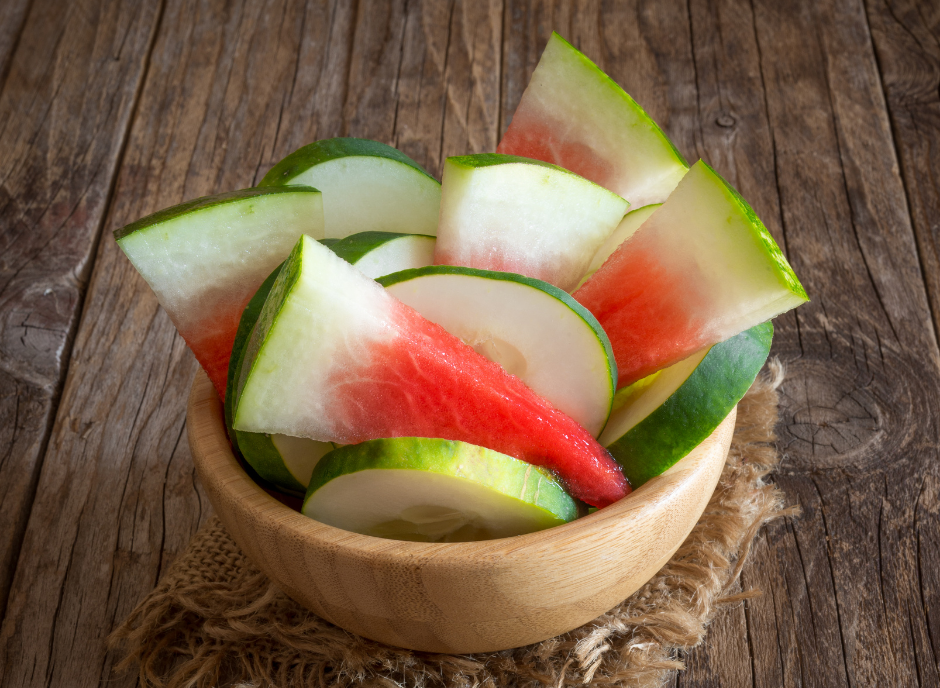 Watermelon slices in a wooden bowl.