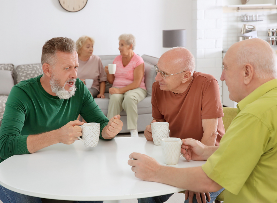 A group of older people sitting around a table.