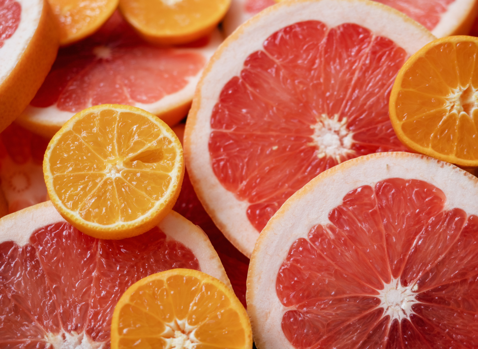 A close up of grapefruits and oranges.