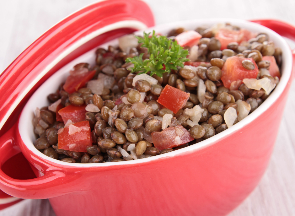 Lentils, which are good for kidney disease, in a red bowl on a wooden table.