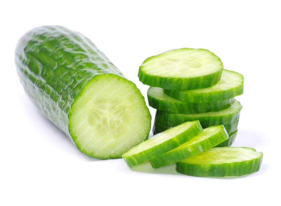 A fresh cucumber partially sliced into thin rounds, isolated on a white background.